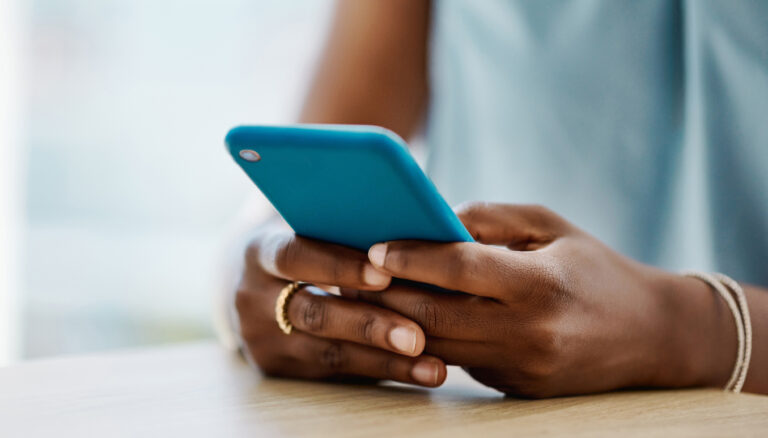 African woman texting on cellphone